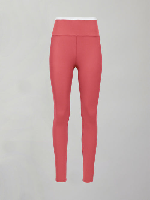 Model wears a buttery soft high waisted rosewood legging with thin white waistband. 