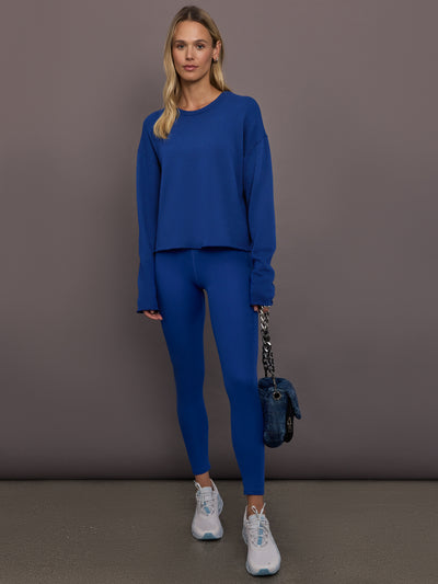 Model is wearing Rib Melt High-Rise Legging in Cobalt, full body view.