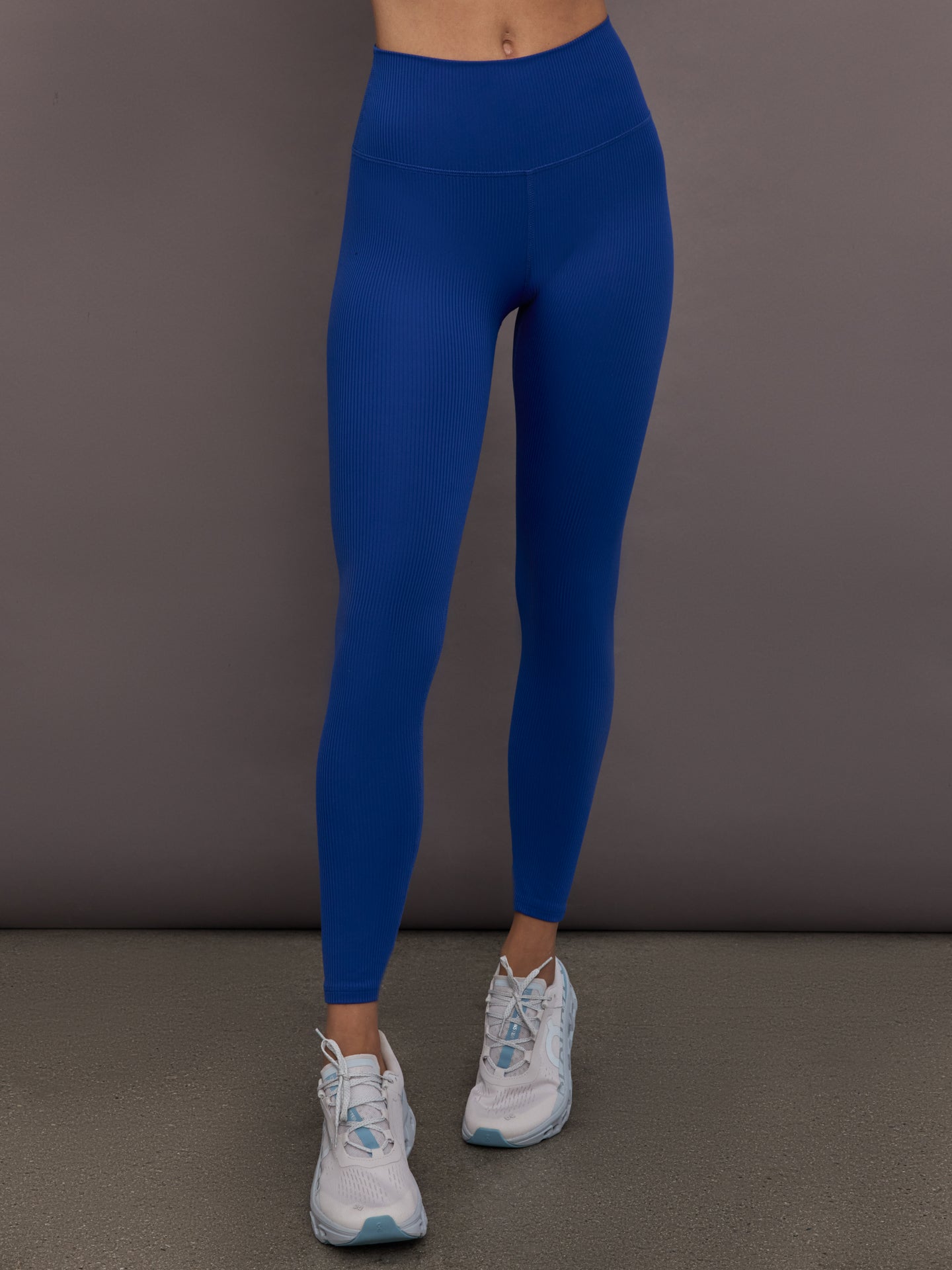 Model is wearing Rib Melt High-Rise Legging in Cobalt, front view.