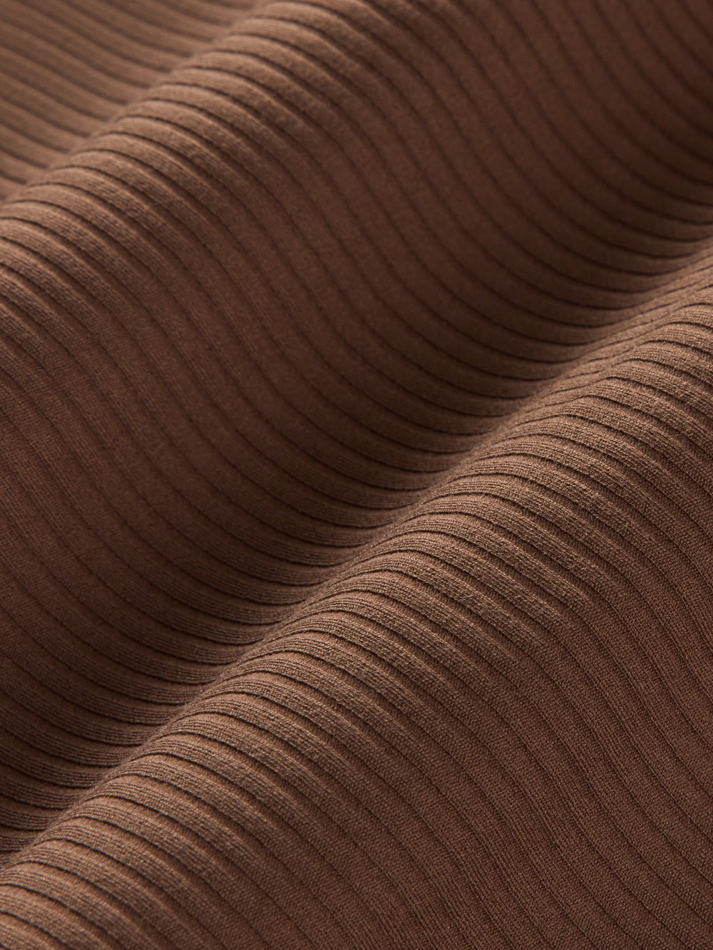 Macro close-up of ribbed melt fabric in Cocoa Brown showing textured stretch material.