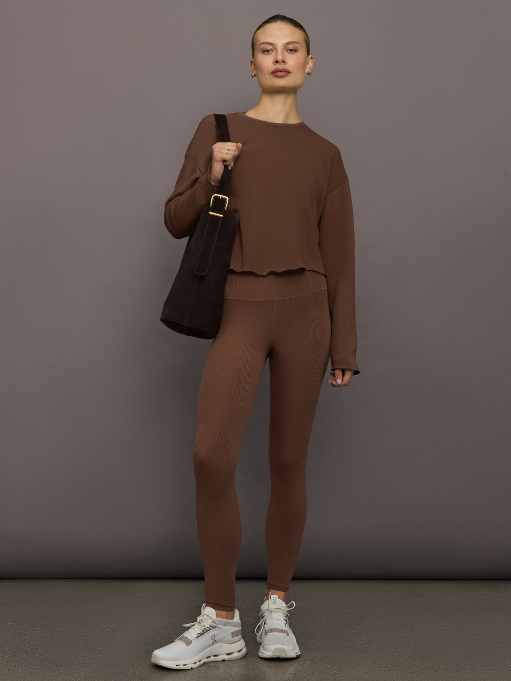 Full outfit with cocoa brown ribbed high-rise leggings styled with matching sweatshirt and white sneakers, front view.