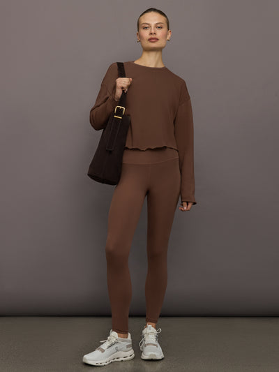 Full outfit with cocoa brown ribbed high-rise leggings styled with matching sweatshirt and white sneakers, front view.