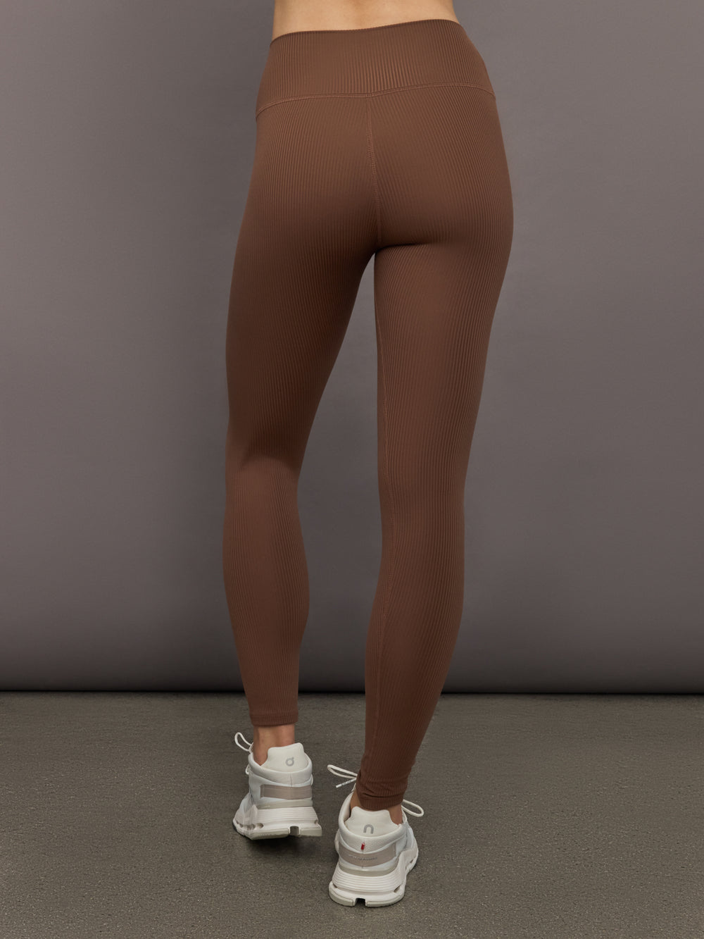 Back view of cocoa brown ribbed high-rise leggings highlighting contoured waistband and seamless fit.