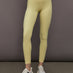 Model is wearing Melt Rib High Rise Legging in Banana, front view.