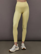 Model is wearing Melt Rib High Rise Legging in Banana, front view.