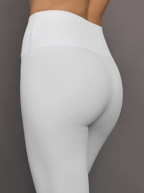 Close-up of ribbed white high-rise leggings waistband and hip detail.