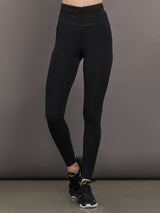 Model wears the Melt and Mesh Ruched Legging in Black, with ruched detailing at the waistband and breathable mesh for a sculpted look.