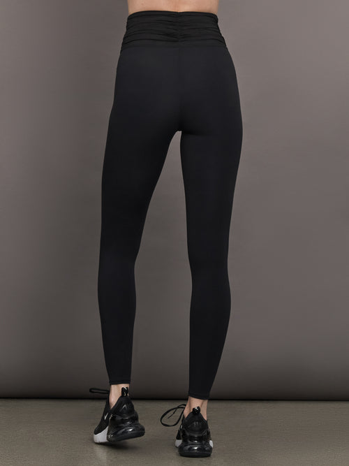 Model wears the Melt and Mesh Ruched Legging in Black, with ruched detailing at the waistband and breathable mesh for a sculpted look.