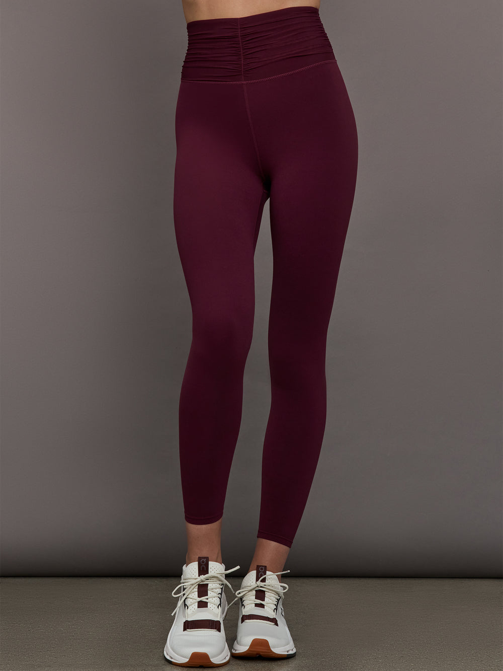Model wearing Fig colored leggings with a rushed waist