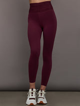 Model wearing Fig colored leggings with a rushed waist