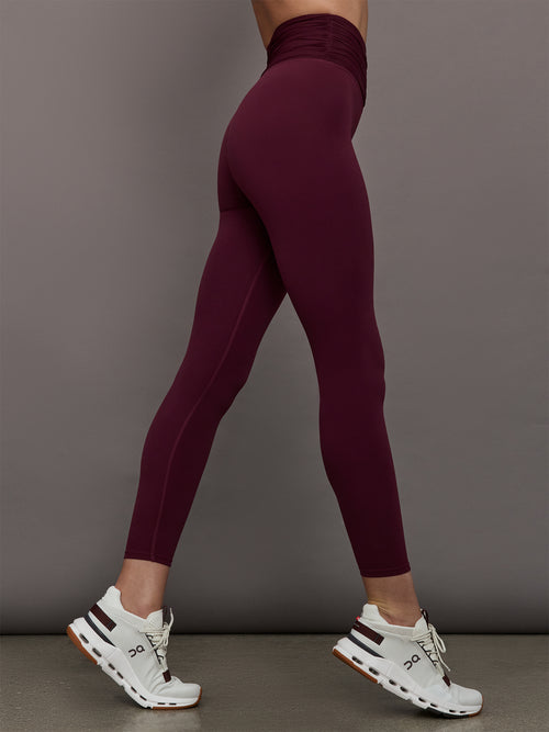 Model wearing Fig colored leggings with a rushed waist
