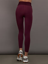 Model wearing Fig colored leggings with a rushed waist