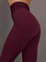 Model wearing Fig colored leggings with a rushed waist