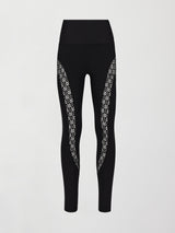 A pair of black high waisted leggings with laser cutouts along thighs. 
