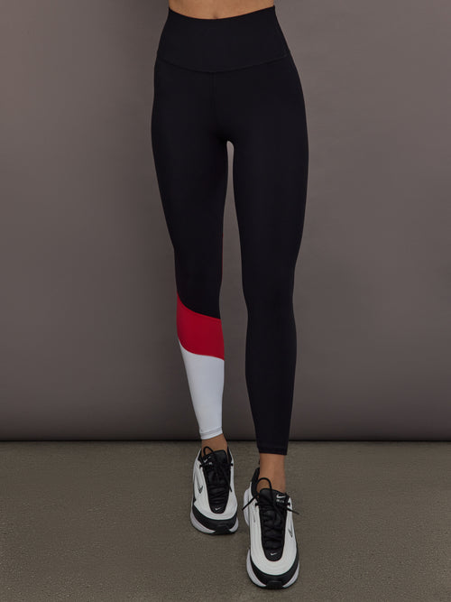 Model is wearing Melt high-rise colorblock legging in black crimson white, front view.