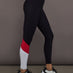 Model is wearing Melt high-rise colorblock legging in black crimson white, side view.