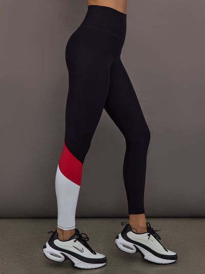 Model is wearing Melt high-rise colorblock legging in black crimson white, side view.
