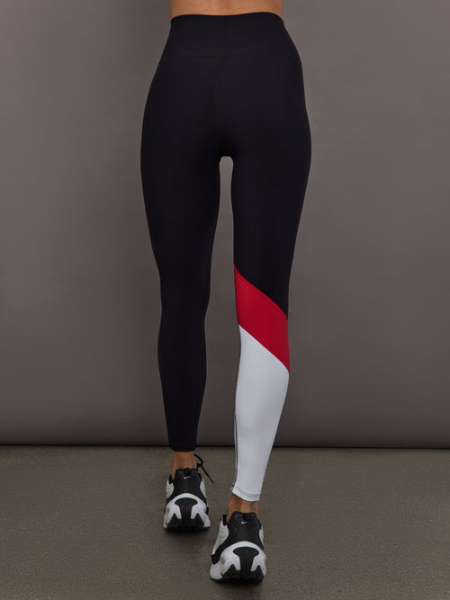 Model is wearing Melt high-rise colorblock legging in black crimson white, back view.