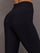 Model is wearing Melt high-rise colorblock legging in black crimson white, close-up waistband detail.