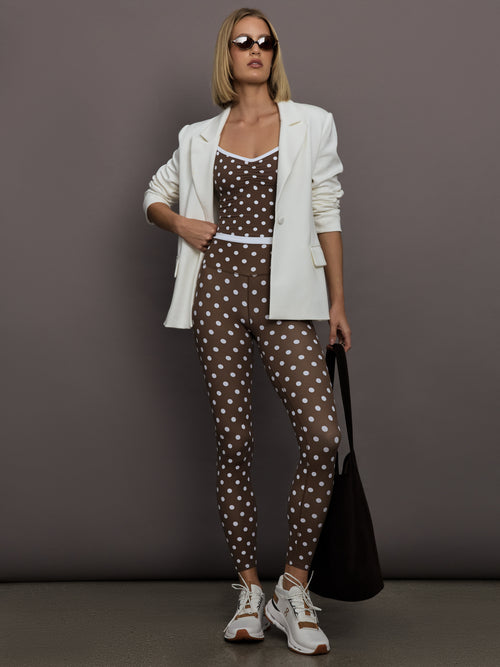Model is wearing the Melt High-Waisted Legging in Carafe White Polka Dot, full body view.