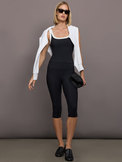 Model is wearing High Rise Capri Legging in Melt Black, full front view showing streamlined fit and mid-calf cut.
