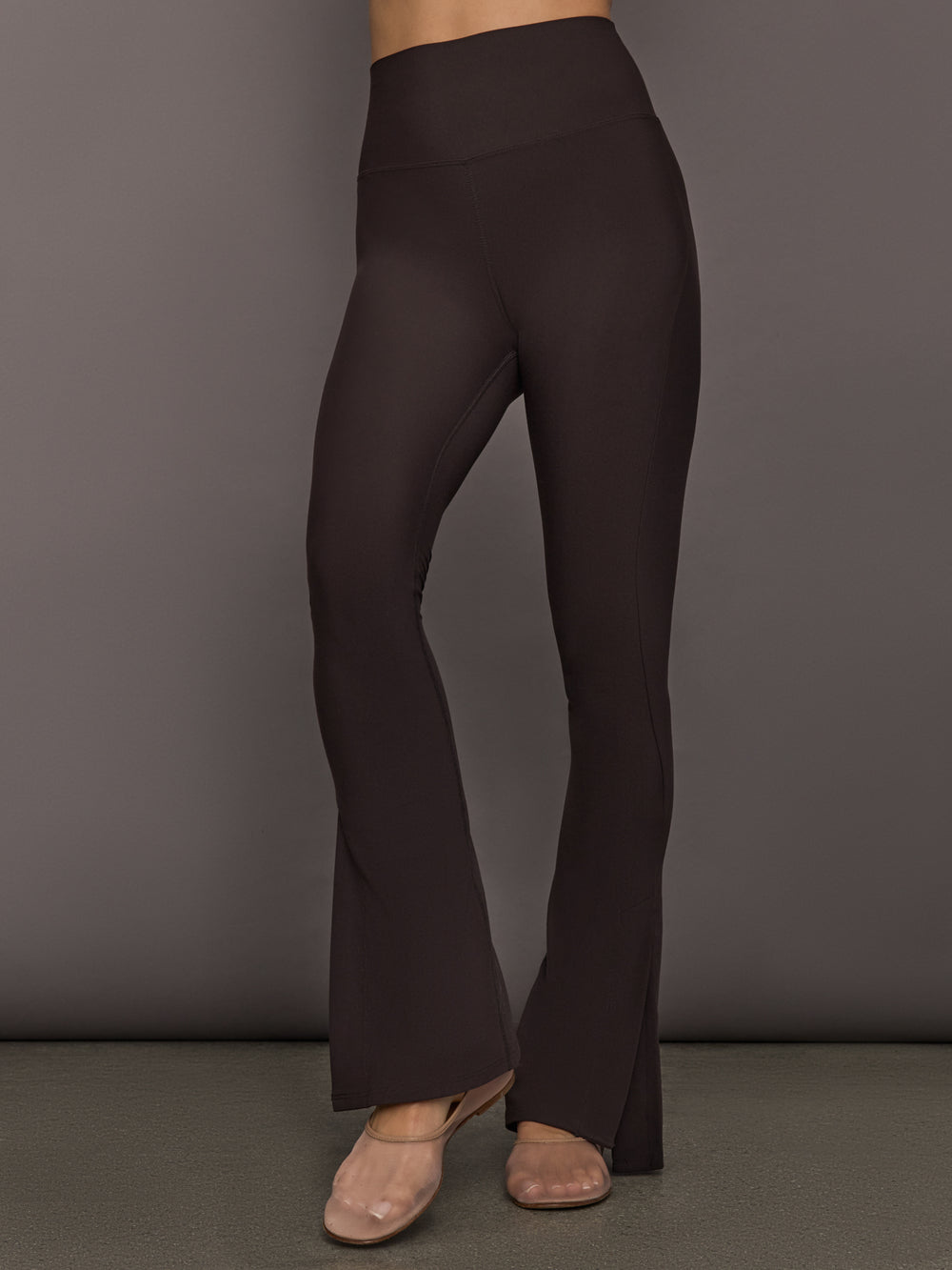 High rise Dark brown flared leggings  perfect for pilates or yoga worn by a model, front view. 