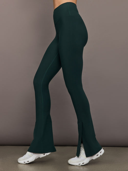 Model is wearing the Split Bootcut Legging in Forest, side profile.