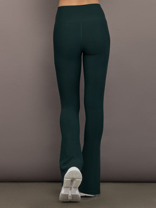 Model is wearing the Split Bootcut Legging in Forest, back view.