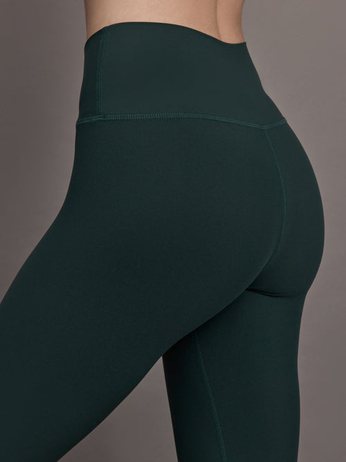 Close up of the High Rise Legging in Forest, waistband and hip detail.