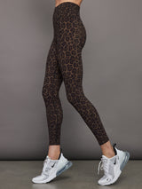 Model wears high waisted brown leopard print leggings. 