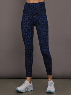 Model is wearing the High Rise Legging in Melt in Navy Leopard shown from the front.