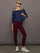 Red leopard Melt leggings with navy off-shoulder sweatshirt and sneakers, full outfit view.