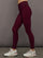 Model in high-rise red leopard Melt leggings showing sleek fit and waistband detail, side view.