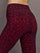 Waistband and hip seam detail of Melt leggings in red leopard pattern, close-up back view.