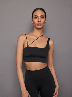 Model wearing the Asymmetrical Strappy Bra in Diamond Compression Black, front close-up view.
