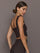 Model is wearing a dark brown square-neck cropped tank top with wide straps, showing fitted side profile, styled with matching leggings, side view.