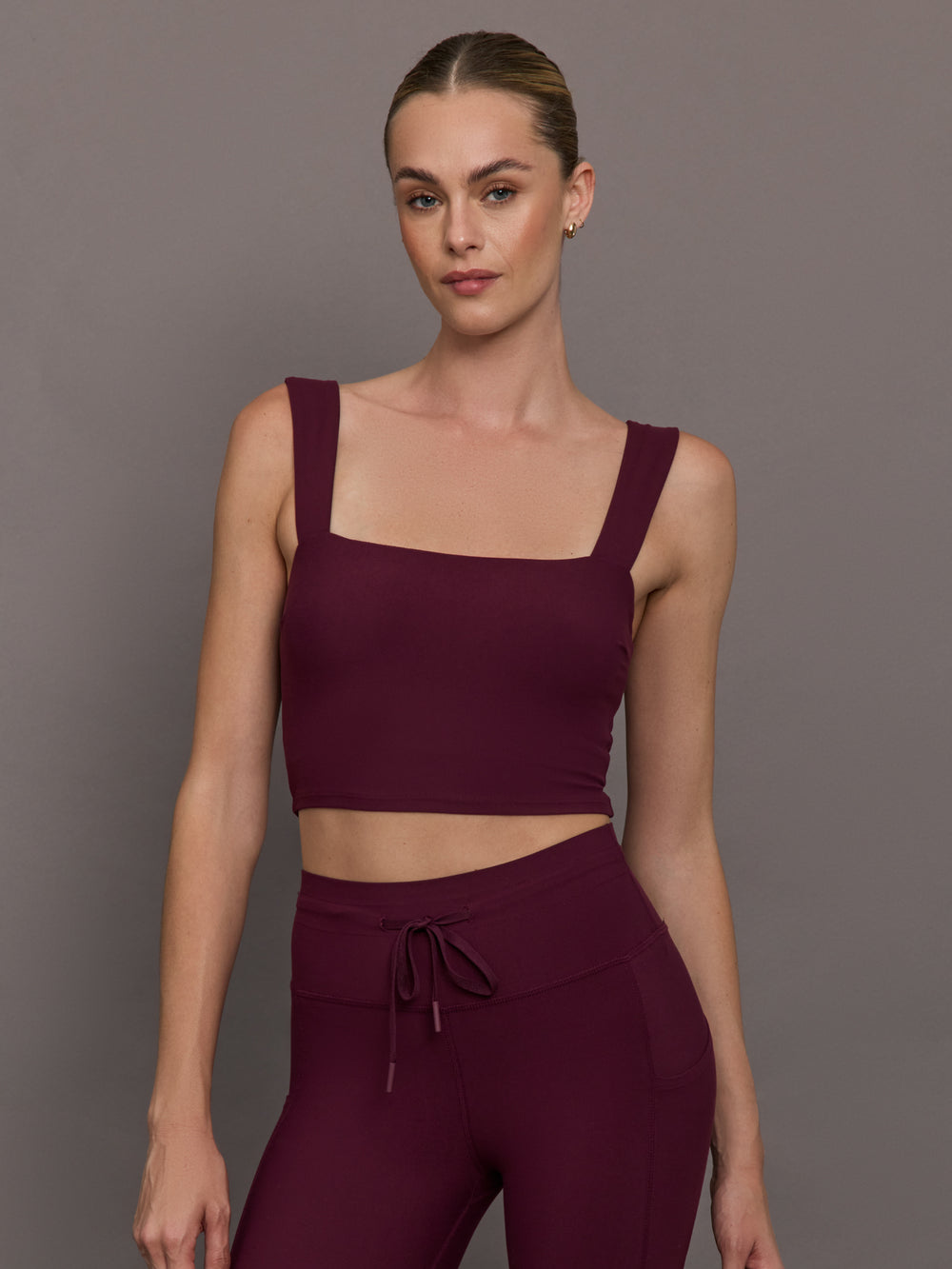Model wearing a fig bra top with a square neck