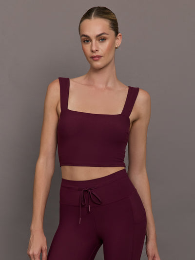 Model wearing a fig bra top with a square neck