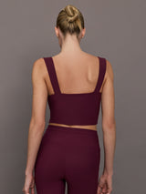 Model wearing a fig bra top with a square neck