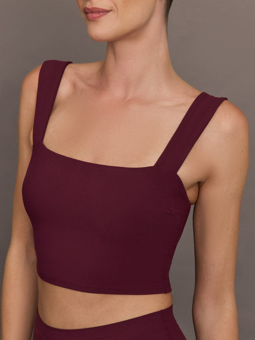 Model wearing a fig bra top with a square neck