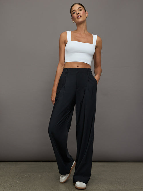 Full body view of model wearing Square Neck Bra Top in White styled with black wide-leg pants.