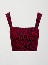 Flat lay of Melt square neck sports bra in red leopard print on white background.