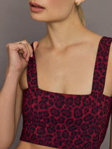 Close-up of Melt red leopard square neck sports bra showing strap and neckline detail.