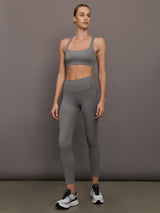Model is wearing Ribbed Melt High Rise Legging in Steel Grey with matching sports bra, full body view.