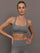 Model wears steel grey-colored racerback bra with a ribbed texture, square neckline, and wide straps that merge at the back.
