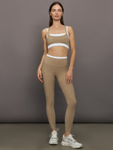 Model wears a white with chinchilla overlay sports bra perfect for medium impact activities. 