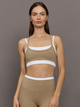 Model wears a white with chinchilla overlay sports bra perfect for medium impact activities. 