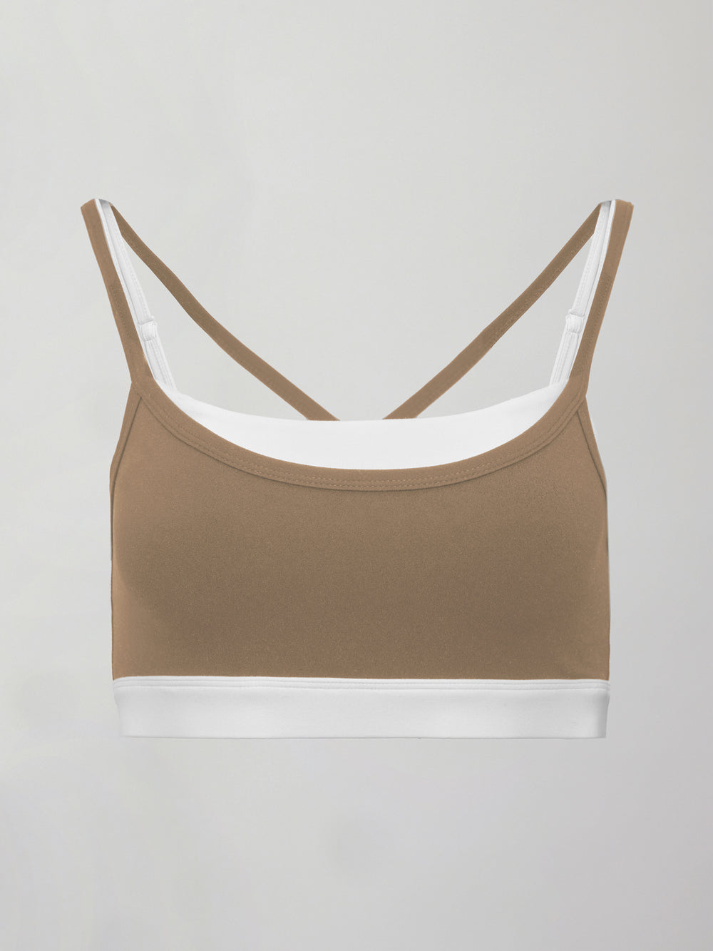 Model wears a white with chinchilla overlay sports bra perfect for medium impact activities. 