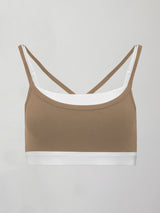 Model wears a white with chinchilla overlay sports bra perfect for medium impact activities. 