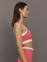 Model wears a white with rosewood overlay sports bra perfect for medium impact activities. 